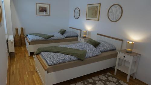 two beds in a bedroom with two lights on the wall at Casa di Traditionale im Herzen von Bad Aibling Tradition trifft auf moderne Gemütlichkeit auf 138qm in Bad Aibling