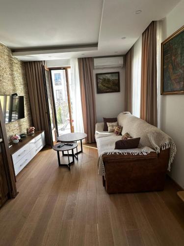 a living room with a couch and a table at Crown TiM Villa in Vrnjačka Banja