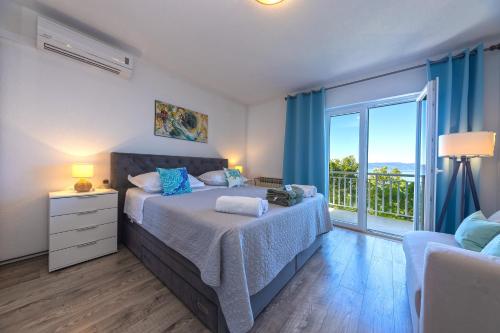 a bedroom with a bed and a large window at Villa Vineyard oaza in Brela
