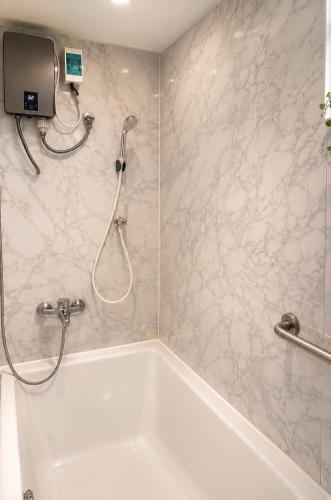a bathroom with a shower and a bath tub at Affordable pool villa in premium location in Pattaya
