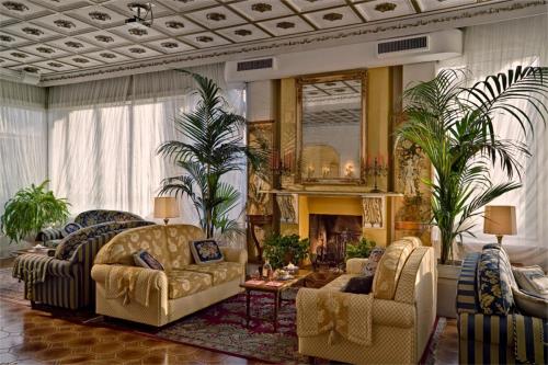 a living room with two couches and a fireplace at Hotel Quisisana Terme in Abano Terme