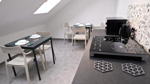 a kitchen with a stove and a table with chairs at Villa Bianco in Międzyzdroje
