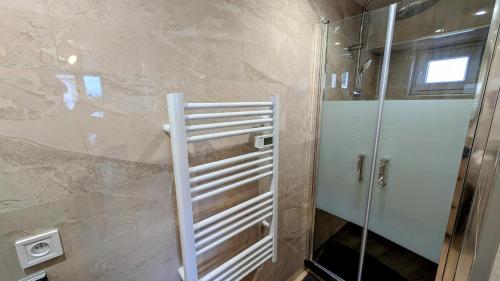 a shower with a glass door in a bathroom at L'appart de saint léo in Saint-Léonard-de-Noblat