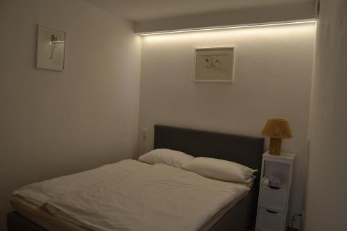 a bedroom with a bed with a light on it at Am Burg in Klotten