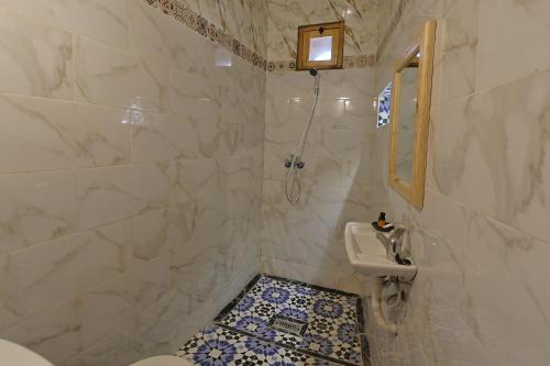 a bathroom with a toilet and a sink at Eagle Lodge in Imlil