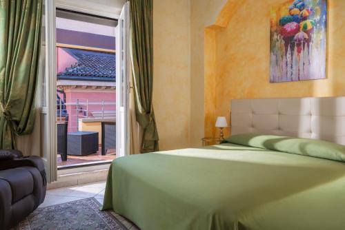 a bedroom with a bed and a large window at Hotel Roma in Bologna