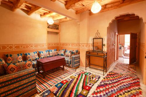 a living room with a couch and a table at Eagle Lodge in Imlil