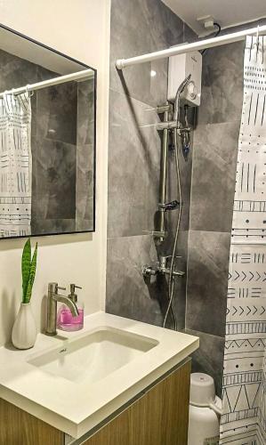 a bathroom with a sink and a shower at Althea's Horizon Stay - Primeworld District in Pajak