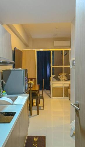 a kitchen with a table and a dining room at Althea's Horizon Stay - Primeworld District in Pajak
