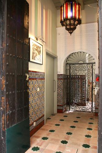 a room with a gate and a room with a tile floor at Hotel Boutique Casas de Santa Cruz in Seville