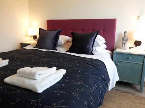 a bedroom with a large bed with towels on it at Cozy Stay Corfu – Studio 10 in Gouvia