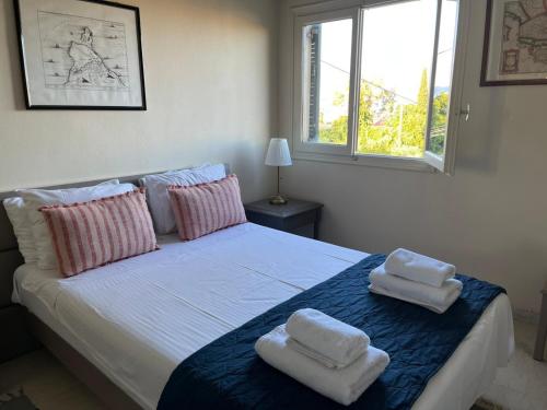 a bedroom with a bed with two towels on it at Cozy 2BR Corfu – Apt 9 in Gouvia