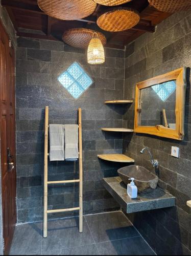 a bathroom with a sink and a mirror at SinCity Nature Private Pool Villa in Tanjung