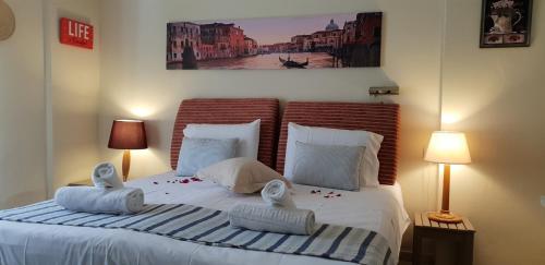 a bedroom with a large bed with two pillows at 2BR Family Gouvia – Apt 2 in Gouvia
