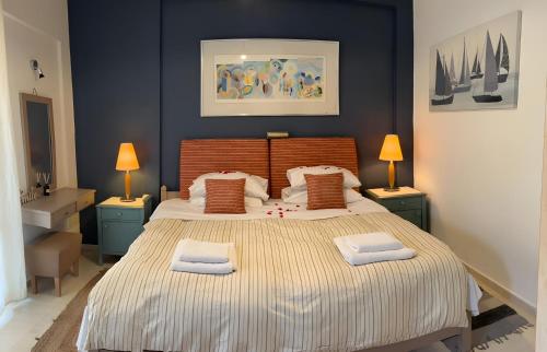 a bedroom with a large bed with two towels on it at Comfy Stay Gouvia – Studio 4 in Gouvia
