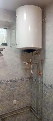 a bathroom with a shower with a white cabinet at Памирский дом in Khorog
