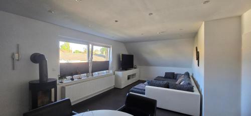 a living room with a couch and a window at Ferienwohnung in Brunsbüttel mit E-Bike Verleih in Brunsbüttel
