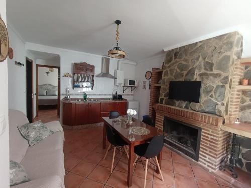 a living room with a table and a fireplace at Los Meri in Grazalema