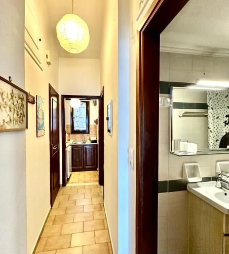 a hallway leading to a kitchen with a sink at Fetsis Apartments in Agios Nikitas