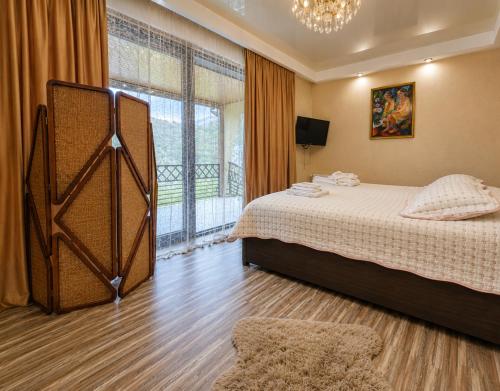 a bedroom with a bed and a large window at Villa Arsha in Arsha