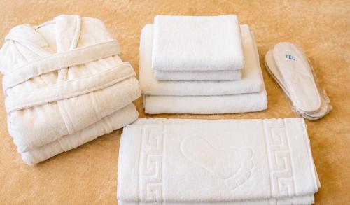a pile of towels sitting on top of a table at Villa Arsha in Arsha