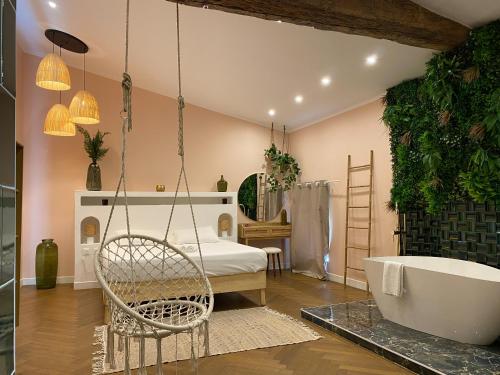 a bedroom with a bathtub and a bed with a bath tub at Mas Beauregard in Anduze