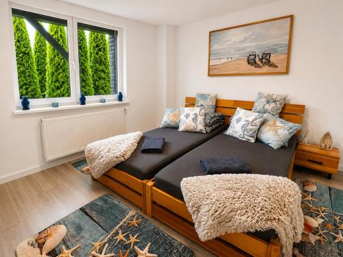 a bedroom with a bed and a window at CHARZYKOWSKIE TARASY in Charzykowy