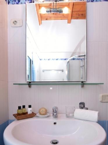 a bathroom with a sink and a mirror at Countryside Villa in Vlorë
