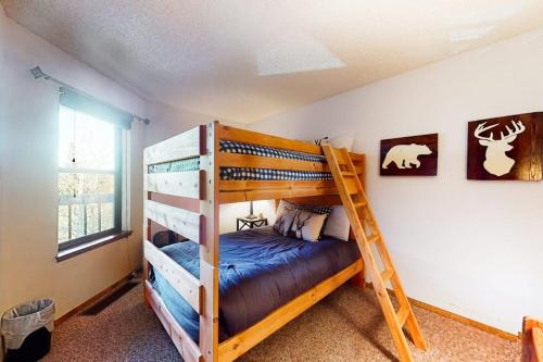 a bedroom with two bunk beds and a ladder at Mountainside Retreat in Frisco