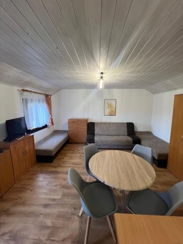 a living room with a table and a couch at Domki letniskowe u Marty in Łeba
