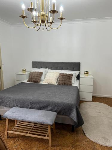 a bedroom with a large bed and a chandelier at Tomorrowland Home in Boom