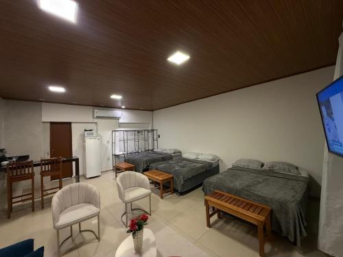 a hospital room with two beds and a tv at Condomínio Feitosa Barros II in Maceió