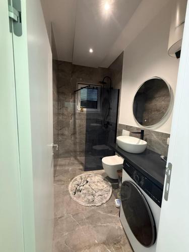 a bathroom with a shower and a toilet and a sink at Villa Lux Una in Bosanska Krupa