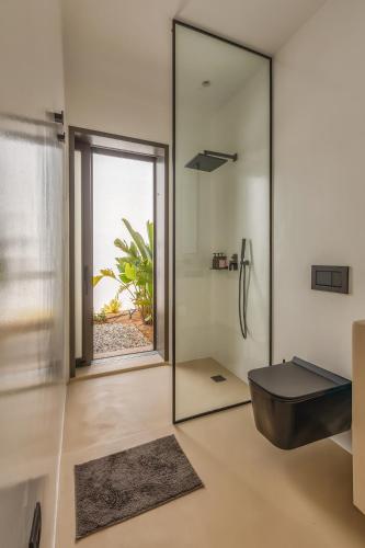 a bathroom with a large mirror and a sink at Skylines Estate Paros in Kampos Paros