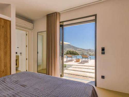 a bedroom with a bed and a view of the ocean at Skylines Estate Paros in Kampos Paros