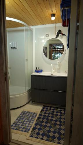 a bathroom with a shower and a sink and a mirror at The Doma in Oral