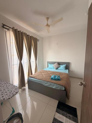 a bedroom with a bed and a window at Jula Hearth 1BHK in Chicalim