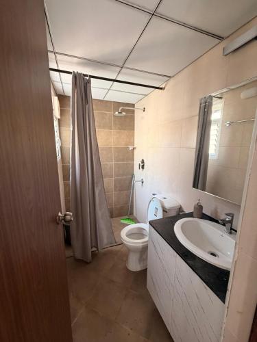 a bathroom with a sink and a toilet and a shower at Jula Hearth 1BHK in Chicalim
