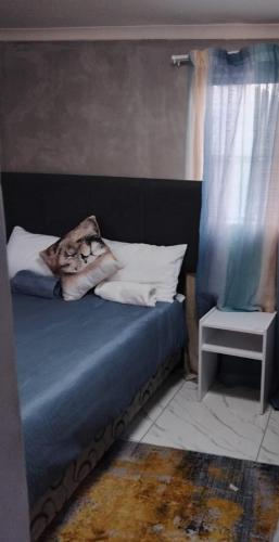 a bed with a person laying on top of it at Vumasky 2 in Ladysmith