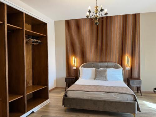 a bedroom with a bed and a wooden floor at Chilometro Mille Suites e Apartments in Otranto