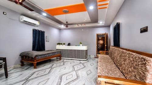 a waiting room with a bed and a desk at Sai krishna residency in Pithāpuram