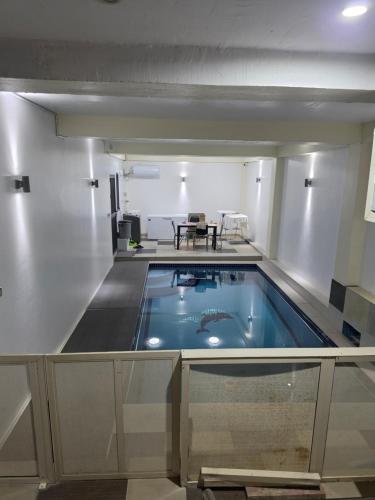 a large swimming pool in a room with a table at 77 Fulaga Flats in Suva