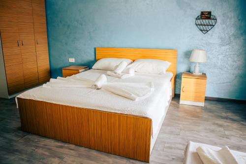 a bedroom with a large bed with white sheets and pillows at Hotel Nur in Mostar