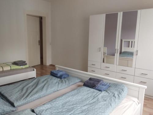 a bedroom with two beds and a large mirror at Apartment Zur Bauhütte, WLAN in Hohenstein-Ernstthal