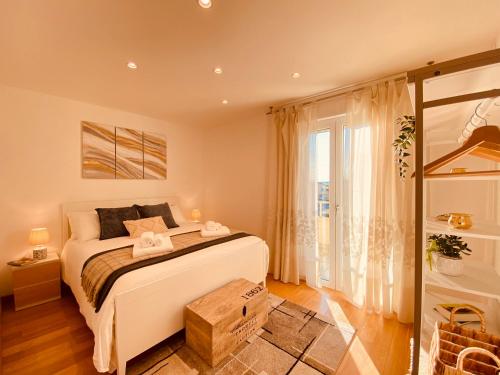 a bedroom with a bed and a large window at Anna's Cozy Nest a Udine in Udine
