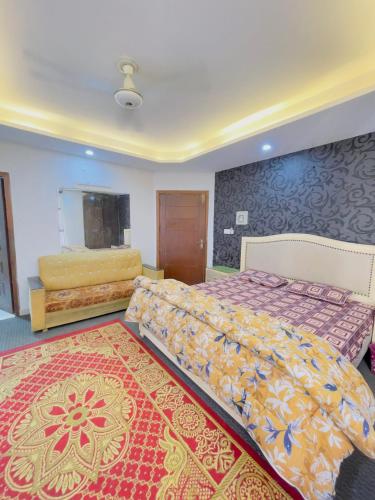 a bedroom with two beds and a rug at Stay lux yellow in Islamabad