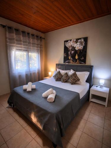 a bedroom with a large bed with towels on it at Sunray Separate Villa in Skala Sotiros