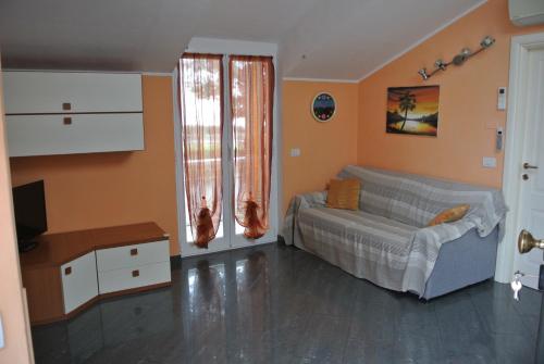 a bedroom with a bed and a television in it at Casa Selly in Loano