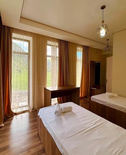 a hotel room with two beds and a piano at Vardzia Hills in Gogasheni