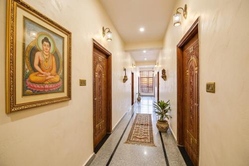 a hallway with a painting of a woman on the wall at Hotel Mounten View Near PEC & PGI in Chandīgarh